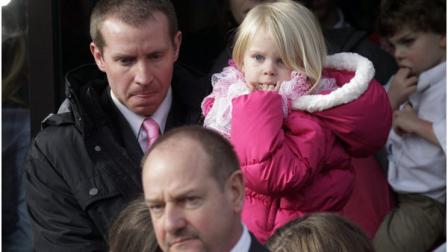 Robbie Parker, left, carries his daughter, Madeline, 4, following funeral services for his 6-year old daughter, Connecticut elementary shooting victim Emilie Parker, Saturday, Dec. 22, 2012, at The Church of Jesus Christ of Latter-day Saints, in Ogden, Utah. Emilie, whose family has Ogden roots, was one of the victims killed in a Dec. 14 mass shooting at Sandy Hook Elementary in Newtown, Conn. (AP Photo/Rick Bowmer)