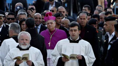 Latin Patriarch of Jerusalem Fouad Twal, center, heads the procession to the Church of Nativity, traditionally believed by Christians to be the birthplace of Jesus Christ, for Christmas celebrations in the West Bank town of Bethlehem, Monday, Dec. 24, 2012. Twal, the top Roman Catholic cleric in the Holy Land, has celebrated the United Nations recent recognition of a Palestinian state in his annual pre-Christmas remarks.(AP Photo/Adel Hana)
