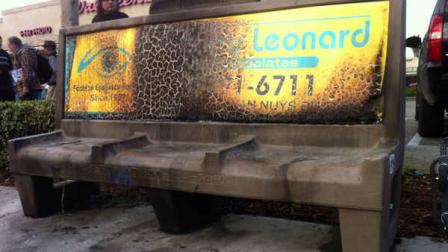A burned city bus bench seen in the Van Nuys section of Los Angeles on Thursday Dec. 27,2012 after police arrested a man for allegedly setting a 67-year-old woman on fire who was sleeping on the bus stop bench. (AP Photo/Greg Risling)