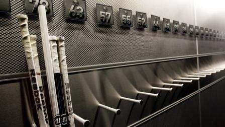 FILE - In this Sept. 25, 2012 file photo, a nearly empty hockey stick rack in the locker room of the Buffalo Sabres hockey team is shown during the NHL labor lockout in Buffalo, N.Y. The NHL lockout thats already wiped out the first three months of the season is taking its toll on Buffalo businesses. And its no different in many of the NHLs 29 other markets. (AP Photo/David Duprey, File)