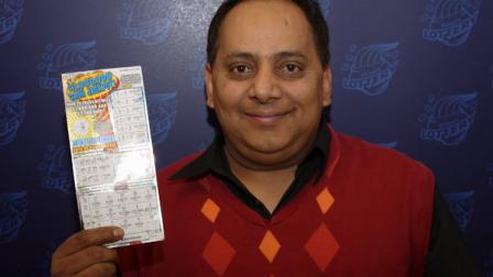 This undated photo provided by the Illinois Lottery shows Urooj Khan, 46, of Chicagos West Rogers Park neighborhood, posing with a winning lottery ticket. The Cook County medical examiner said Monday, Jan. 7, 2013, that Khan was fatally poisoned with cyanide July 20, 2012, a day after he collected nearly $425,000 in lottery winnings. (AP Photo/Illinois Lottery)