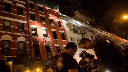 Firefighters respond to a five-alarm fire at a lower Manhattan apartment building that killed one woman Thursday, Jan. 10, 2012, in New York. (AP Photo/John Minchillo)