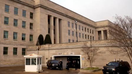Security officials guard the entrance to the Pentagon in Washington, used by the vehicle transporting President Barack Obama for a routine fitness evaluation, according to White House officials, on Saturday, Jan. 12, 2013. (AP Photo/Jacquelyn Martin)