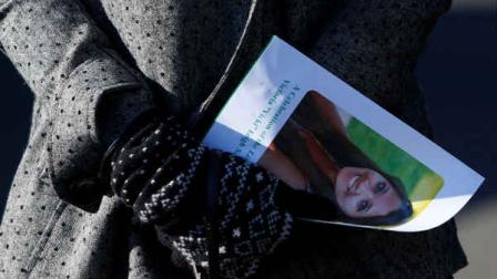 A mourner carries a program as she leaves the funeral service of VictoriaSoto at Lordship Community Church, Wednesday, Dec. 19, 2012, in Stratford, Conn. Soto was killed when Adam Lanza walked into Sandy Hook Elementary School in Newtown, Conn., Dec. 14, and opened fire, killing 26 people, including 20 children, before killing himself. (AP Photo/Jason DeCrow)