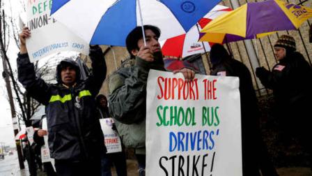 Bus drivers and supporters walk a picket line in front of a bus depot in New York, Wednesday, Jan. 16, 2013. More than 8,000 New York City school bus drivers and matrons went on strike over job protection Wednesday morning, leaving some 152,000 students, many disabled, trying to find other ways to get to school. (AP Photo/Seth Wenig)