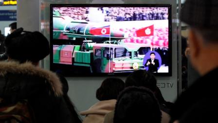 People watch a TV news showing file footage of a North Korean rocket carried during a military parade, at Seoul Railway Station in Seoul, South Korea, Thursday, Jan. 24, 2013. North Koreas top governing body warned Thursday that the regime will conduct its third nuclear test in defiance of U.N. punishment, and made clear that its long-range rockets are designed to carry not only satellites but also warheads aimed at striking the United States. (AP Photo/Ahn Young-joon)