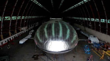 The Aeroscraft airship, a high-tech prototype airship, is seen in a World War II-era hangar in Tustin, Calif., Thursday, Jan. 24, 2013. Work is almost done on a 230-foot rigid airship inside a blimp hangar at a former military base in Orange Co. The huge cargo-carrying airship is has shiny aluminum skin and a rigid, 230-foot aluminum and carbon fiber skeleton. (AP Photo/Jae C. Hong)