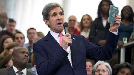 New Secretary of State JohnKerry shows his first diplomatic passport he got when he was eleven years old when his father was in the foreign service, during a ceremony welcoming him as the 68th secretary of state, Monday, Feb. 4, 2013, at the State Department in Washington. (AP Photo/Manuel Balce Ceneta)