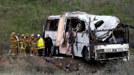 San Bernardino Fire Department Investigators Monday Feb. 4, 2013 examine the wreckage after a tour buscrash in the mountains near San Bernardino Sunday. The tour bus carrying dozens of men, women and children from Tijuana, Mexico, crashed in the mountains of Southern California killing at least seven people, authorities said. ( AP Photo/Nick Ut)