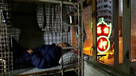 In this Jan. 25, 2013 photo, 62-year-old Cheng Man Wai lays in his cage, measuring 1.5 square meters (16 square feet), which he calls home, in Hong Kong. (AP Photo/Vincent Yu)
