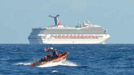 In this image released by the U.S. Coast Guard on Feb. 11, 2013, a small boat belonging to the Coast Guard Cutter Vigorous patrols near the cruiseship Carnival Triumph in the Gulf of Mexico, Feb. 11, 2013. The Carnival Triumph has been floating aimlessly about 150 miles off the Yucatan Peninsula since a fire erupted in the aft engine room early Sunday, knocking out the ships propulsion system. No one was injured and the fire was extinguished. (AP Photo/U.S. Coast Guard- Lt. Cmdr. Paul McConnell)