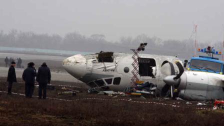 Ukrainian AN-24 plane is seen after crash outside an airport in the eastern Ukrainian city of Donetsk, Thursday, Feb. 14, 2013. A passenger plane carrying soccer fans headed for a match between Shakhtar and Borussia Dortmund, skidded past the landing strip and overturned on Wednesday, killing five people, officials said. The plane was carrying 44 passengers and crew from the Black Sea port of Odessa when it crash-landed. (AP Photo/Irina Gorbaseva)