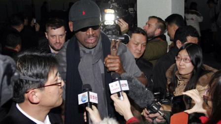 Flamboyant former NBA star Dennis Rodman is surrounded by journalists upon arrival at Pyongyang Airport, North Korea, Tuesday, Feb. 26, 2013. The American known as The Worm arrived in Pyongyang, becoming an unlikely ambassador for sports diplomacy at a time of heightened tensions between the U.S. and North Korea. (AP Photo/Kim Kwang Hyon)