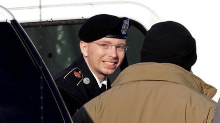 FILE - In this Nov. 28, 2012 file photo, Army Pfc. Bradley Manning, center, steps out of a security vehicle as he is escorted into a courthouse in Fort Meade, Md., for a pretrial hearing. (AP Photo/Patrick Semansky, HO)