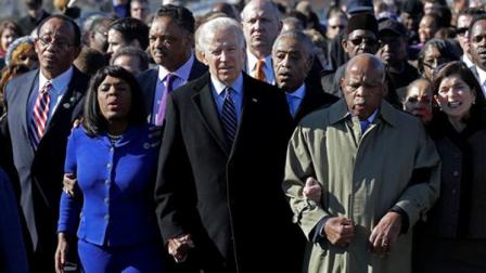 Vice President Joe Biden, center, leads a group across the Edmund Pettus Bridge in Selma, Ala., Sunday, March 3, 2013. They were commemorating the 48th anniversary of Bloody Sunday, when police officers beat marchers when they crossed the bridge on a march from Selma to Montgomery. From left: Selma Mayor George Evans, U.S. Rep. Terri Sewell, D-Ala., Rev. Jesse Jackson, Biden, Rev. Al Sharpton and U.S. Rep. John Lewis, D-Ga. (AP Photo/Dave Martin)