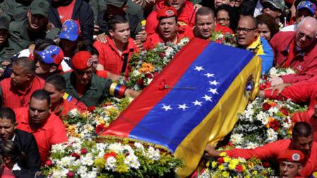 The flag-draped coffin containing the body of Venezuelas late President Hugo Chavez is taken from the hospital where he died, to a military academy where it will remain until his funeral in Caracas, Venezuela, Wednesday, March 6, 2013. Seven days of mourning were declared, all schools were suspended for the week and friendly heads of state were expected for an elaborate funeral Friday. (AP Photo/Ricardo Mazalan)