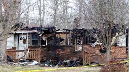 This photo shows the charred remains of a home after a fire erupted, Saturday, March 9, 2013 in Gray, Ky. Fire erupted Saturday at a rural Kentucky home, killing two adults and five children inside. Sunday, March 10, 2013 in Gray, KY. (AP Photo/Lisa Norman-Hudson)