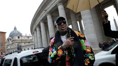 Former NBA star Dennis Rodman walks next to the Bernini Colonnade near St. Peters Square at the Vatican, Wednesday, March 13, 2013. Rodman is in Rome to promote the papal candidacy of Cardinal Peter Turkson of Ghana. (AP Photo/Andrew Medichini)