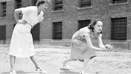 FILE: Ruth Steinhagen, right, 19-year-old Chicago girl held for the shooting of Eddie Waitkus, Philadelphia Phillies first baseman. Steinhagen plays ball with inmates of the Cook County Jail in Chicago, June 18, 1949. Mrs. Ann Markov, chief Matron, takes the role of umpire. (AP Photo)