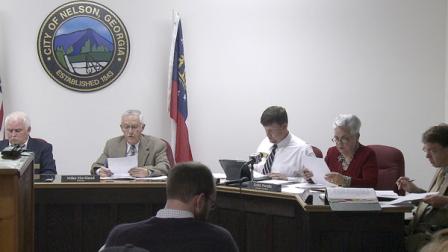 In a photo made from video the Nelson, Ga. City Council meets to vote on a mandatory gun ownership ordinance for all heads-of-household, Monday, April 1, 2013, in Nelson Ga. Left to right: Council member Jackie Jarrett, Mayor Mike Haviland, council member Duane Cronic, council member Edith Portillo, city attorney Jeff Rusbridge. The ordinance in the city of Nelson _ population 1,300 _ was approved Monday night and goes into effect in 10 days. However, it contains no penalties and exempts anyone who objects, convicted felons and those with certain mental and physical disabilities. (AP Photo/Johnny Clark)