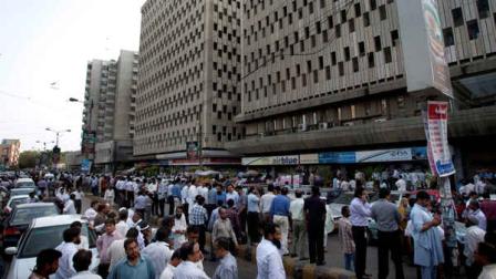 People evacuate buildings after a major earthquake hit Karachi, Pakistan, Tuesday, April 16, 2013. A major earthquake described as the strongest to hit Iran in more than half a century flatted homes and offices Tuesday near Irans border with Pakistan, killing at least tens of people in the sparsely populated region and swaying buildings as far away as New Delhi and the skyscrapers in Dubai and Bahrain. (AP Photo/Shakil Adil)