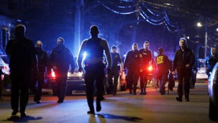Police officers walk near a crime scene Friday, April 19, 2013, in Watertown, Mass. A tense night of police activity that left a university officer dead on campus just days after the Boston Marathon bombings and amid a hunt for two suspects caused officers to converge on a neighborhood outside Boston, where residents heard gunfire and explosions.