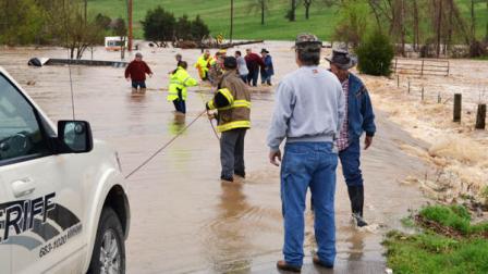 This photo provided by the Douglas County, Mo., Sheriff shows authorities rescuing an elderly couple that had been trapped in their flooded mobile home by flash flooding from heavy downpours Thursday, April 17, 2013, near Ava, Mo. Officials say the state water patrol boat, left, helping with the rescue capsized after getting tangled in flooded barbed wire. The rescue crew and the elderly couple are OK. (AP Photo/Douglas County Sheriff)