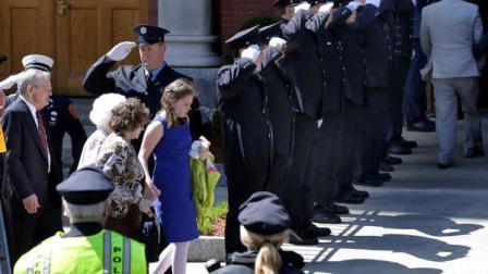 A Fire Department honor guard salutes as mourners file into St. Josephs Church in Medford, Mass. Monday, April 22, 2013 for the funeral of Boston Marathon bomb victim Krystle Campbell, 29. (AP Photo/Elise Amendola)
