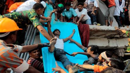 Rescuers lower down a survivor from the debris of a building that collapsed in Savar, near Dhaka, Bangladesh, Wednesday, April 24, 2013. An eight-story building housing several garment factories collapsed near Bangladeshs capital on Wednesday, killing dozens of people and trapping many more under a jumbled mess of concrete. Rescuers tried to cut through the debris with earthmovers, drilling machines and their bare hands. (AP Photo/A.M.Ahad)
