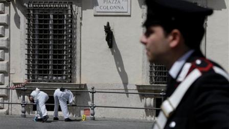 Forensic police study the area where a shooting took place outside Chigi Palace, premiers office, in Rome, Sunday, April 28, 2013. Two Italian paramilitary policemen were shot and wounded Sunday in a crowded square outside the premiers office in Rome as Italys new leader Enrico Letta was being sworn in at the Quirinal presidential office, about a kilometer (half-mile) away. It was not immediately clear if there was any connection between the shooting and the swearing-in. (AP Photo/Alessandra Tarantino)