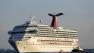 FILE - In this Feb. 14, 2013 file photo the cruise ship Carnival Triumph is towed into Mobile Bay near Dauphin Island, Ala., Thursday, Feb. 14, 2013. A leak in a fuel oil return line caused the engine-room fire that disabled a Carnival cruise ship at sea, leaving 4,200 people without power or working toilets for five days, a Coast Guard official said Monday, Feb. 18, 2013. (AP Photo/Dave Martin, File)  