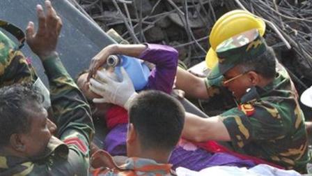 Rescuers carry a survivor pulled out from the rubble of a building that collapsed in Saver, near Dhaka, Bangladesh, Friday, May 10, 2013. Rescue workers in Bangladesh freed the woman buried for 17 days inside the wreckage of a garment factory building that collapsed, killing more than 1,000 people. Soldiers at the site said her name was Reshma and described her as being in remarkably good shape despite her ordeal. (AP Photo/Parvez Ahmad Rony)