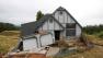 This photo taken Monday, May 6, 2013 shows the wreckage of the Tudor-style dream home of Robin and Scott Spivey who were forced to abandon after the ground gave way causing it to drop 10 feet below the street in Lakeport, Calif. Officials believe that water that has bubbled to the surface is playing a role, in the collapse of the hillside subdivision that has forced the evacuation of 10 homes and the notice of imminent evacuation of another 10 in this upscale subdivision.(AP Photo/Rich Pedroncelli)