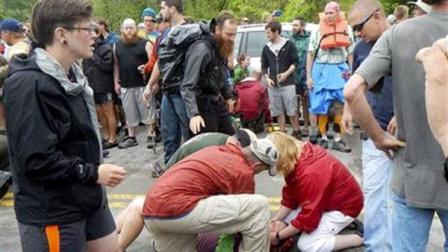 People attend to a victim who was hit by a car during the Hikers Parade at the Trail Days festival in Damascus, Va., Saturday, May 18, 2013. Witnesses said the car drove into a crowd at the parade and hurt several people, but the nature of their injuries wasnt immediately known. (AP Photo/Republican-American, Bill OBrien)