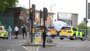 A tent is erected near the scene of an attack in Woolwich southeast London Wednesday, May, 22, 2013. British officials said one person has died and at least two people have been wounded in an attack in southeast London. Scotland Yard said officers responded to reports of an assault Wednesday afternoon in the London neighbourhood of Woolwich. London Ambulance service said one man was found dead at the scene and two other men were taken to the hospital, with one in serious condition. (AP Photo/Alastair Grant)