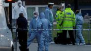 Police and forensic officers near the scene of an attack which has left one man confirmed dead and two people injured near Woolwich barracks in London Wednesday, May, 22, 2013. Scotland Yard said officers responded to reports of an assault Wednesday afternoon in the London neighbourhood of Woolwich. London Ambulance service said one man was found dead at the scene and two other men were taken to the hospital, with one in serious condition. (AP Photo/Alastair Grant)