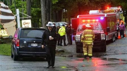 In this Friday, May 24, 2013 photo, rescue workers move about the staging area at Grannys Ice Cream across from the site of a plane crash in a wooded area off Route 10 in the town of Fulton in Ephratah, N.Y., after a small plane crashed killing two people. (AP Photo/The Daily Gazette, Peter R. Barber) TROY, SCHENECTADY; SARATOGA SPRINGS; ALBANY AND AMSTERDAM OUT