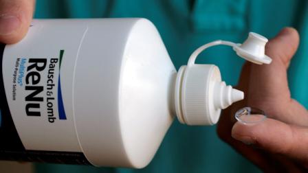 A drop of Bausch and Lomb eye care product is about to be poured on the contact of Brent Yamashita in Palo Alto, Calif., Wednesday, May 16, 2007. (AP Photo/Paul Sakuma)
