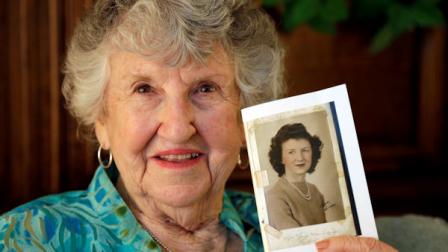 In this Thursday, May 23, 2013 photo, Laura Mae Davis Burlingame, 90, holds a photo of herself from high school, in her Moorseville, Ind. home. The photo filled the back cover of a diary she had given to a Marine Cpl. Thomas Cotton Jones, a 22-year-old machine gunner, who died in the bloody assault on a Japanese-held island during World War II. Burlingame didnt know the military diary she gave Jones had survived him. She saw it and read, If this Diary is lost and if it is Possible please return it to Miss Laura Mae Davis. Address. Winslow Indiana. (AP Photo/Michael Conroy)