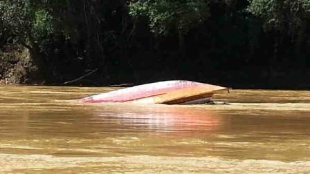 In this photo taken by Belaga state assemblyman Liwan Lagang, the capsized boat floats in a river of Sungai Rajang in Belaga in the state of Sarawak on the Borneo island, Malaysia, Tuesday, May 28, 2013. An overloaded ferry capsized after hitting rocks in a remote river leaving 21 people missing and feared trapped inside the vessel, police said. Another 181 survivors swam ashore or were rescued by villagers. (AP Photo/Liwan Lagang)