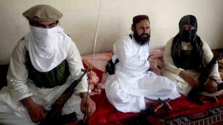 FILE - In this July 28, 2011 file photo, Taliban No 2 commander Waliur Rehman talks to the Associated Press during an interview in Shawal area of South Waziristan along the Afghanistan border in Pakistan. Pakistani intelligence officials say a U.S. drone strike has killed the commander of the Pakistani Taliban. The militant group denies he is dead. (AP Photo/Ishtiaq Mahsud, File)