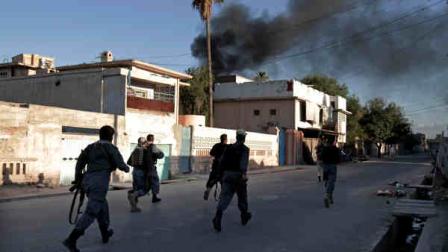 Smoke rises from the International Red Cross building after a gun battle between security forces and an insurgent, in Jalalabad east of Kabul, Afghanistan, Wednesday, May 29, 2013. A senior Afghan official said security forces rescued seven foreigners working for the International Red Cross on Wednesday after a two-hour-long gun battle with an insurgent at a guest house in the eastern city of Jalalabad. (AP Photo/Rahmat Gul)