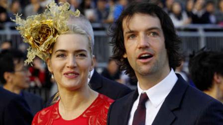 FILE - In this Dec. 9, 2012 file photo, British actress Kate Winslet, left, arrives with Ned Rocknroll at the awards presentation of The Longines Hong Kong Cup horse race at the Shatin race track in Hong Kong. A representative for the 37-year-old Oscar winner confirms Winslet and husband Rocknroll are expecting a child. People.com first reported the pregnancy Tuesday, June 4, 2013. (AP Photo/Kin Cheung, File)