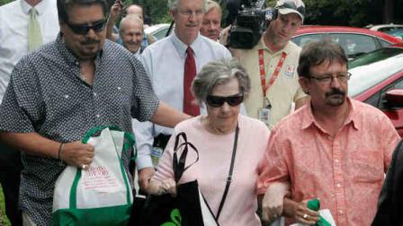 Powerball winner Gloria C. Mackenzie, 84, leaves the lottery office escorted by her son Scott Mackenzie, right, after claiming a single lump-sum payment of about $370.9 million before taxes on Wednesday, June 5, 2013, in Tallahassee, Fla. Officials say she is the largest sole lottery winner in U.S. history. She did not speak to reporters outside lottery headquarters, leaving in a silver Ford Focus with family members. (AP Photo/Steve Cannon)