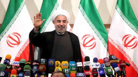 Iranian President-elect Hasan Rowhani waves to media at the start of a press conference in Tehran, Iran, Monday, June 17, 2013. (AP Photo/Ebrahim Noroozi)