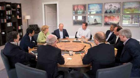 Leaders of the G-8 meet during a round table session at the G-8 summit at the Lough Erne golf resort in Enniskillen, Northern Ireland, on Tuesday, June 18, 2013. From left clockwise, European Commission President Jose Manuel Barroso, Japans Prime Minister Shinzo Abe, German Chancellor Angela Merkel, Russian President Vladimir Putin, British Prime Minister David Cameron, US President Barack Obama, French President Francois Hollande, Canadian Prime Minister Stephen Harper, Italian Prime Minister Enrico Letta. (AP Photo/Stefan Rousseau, Pool)