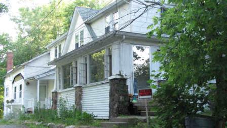 A Private Property No Trespassing sign greets visitors Tuesday June 18, 2013, at this three-apartment building in Ashland, Ohio, which a neighbor says was home to at least one of the three suspects charged with enslaving a mentally disabled woman and her child. (AP Photo/Kantele Franko)
