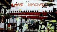 The reconstruction of TWA Flight 800 sits in Calverton, N.Y., in a file handout photo. More than 727 pieces were hung for the reconstruction, which is approximately 94 feet long, and 25 feet wide, and was supervised by The National Transportation Safety Board and the FBI. Image taken through reconstruction grid. (AP Photo/NTSB, HO)
