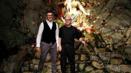 FILE -- In this file photo taken on Jan. 12, 2013, Italian fashion designers Stefano Gabbana, left, and Domenico Dolce bow to the audience after presenting their Dolce and Gabbana mens Fall-Winter 2013-14 collection in Milan, Italy. (AP Photo/Antonio Calanni)