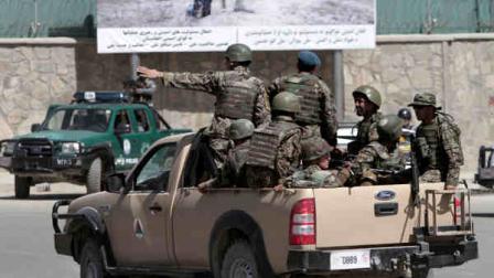 Afghan national security arrive near the entrance gate of the presidential palace in Kabul, Afghanistan Tuesday, June 25, 2013 following an attack. Suicide attackers blew up a car bomb and battled security forces outside Afghanistans presidential palace Tuesday after infiltrating one of the most secure areas of the capital. The Taliban claimed responsibility for the attack that came as reporters were gathering for a news event on Afghan youth at which President Hamid Karzai was expected to talk about ongoing efforts to open peace talks with the militant group. (AP photo/Rahmat Gul)